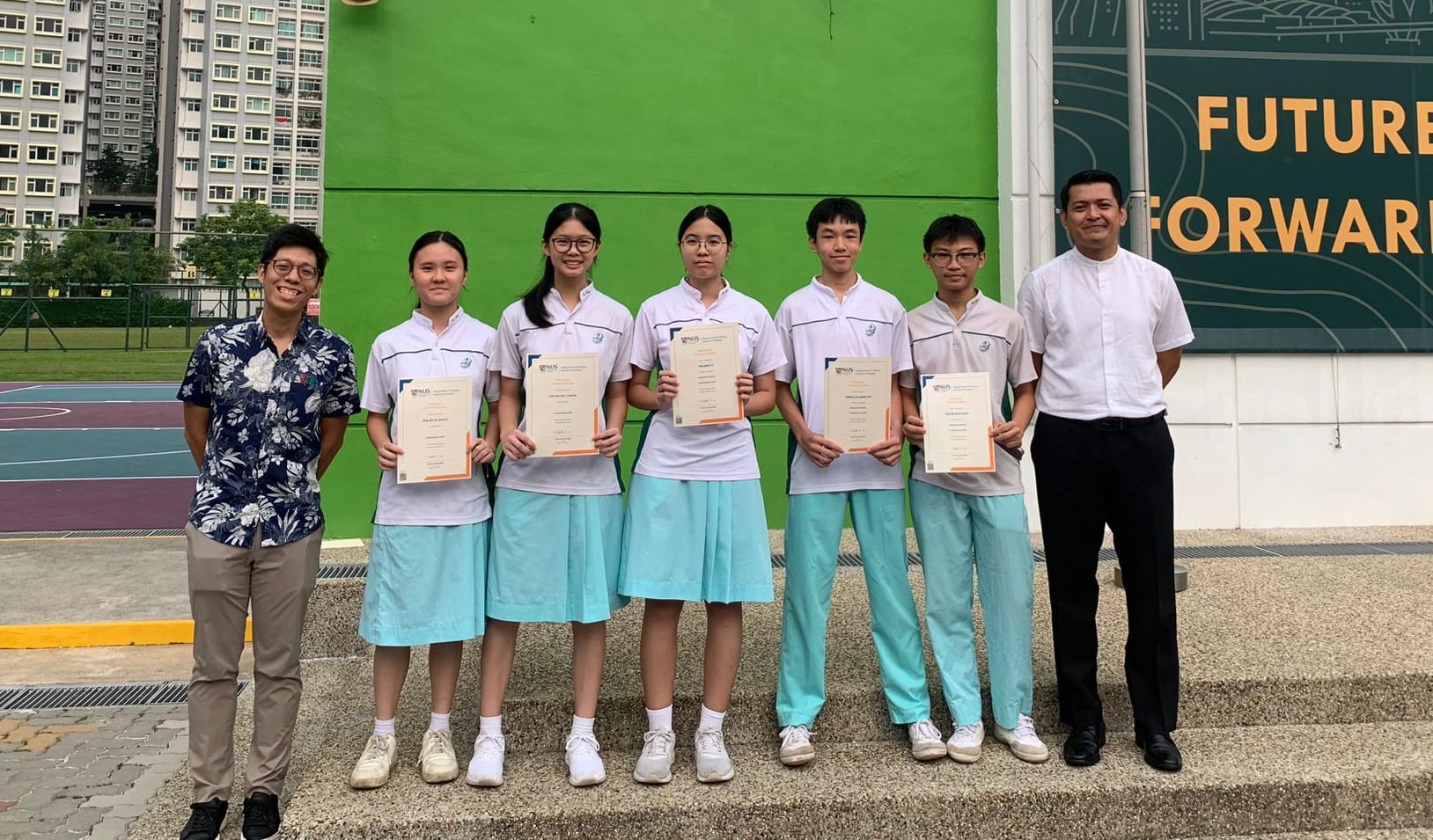 5 students holding a cert taking photo with a teacher as well as the principal
